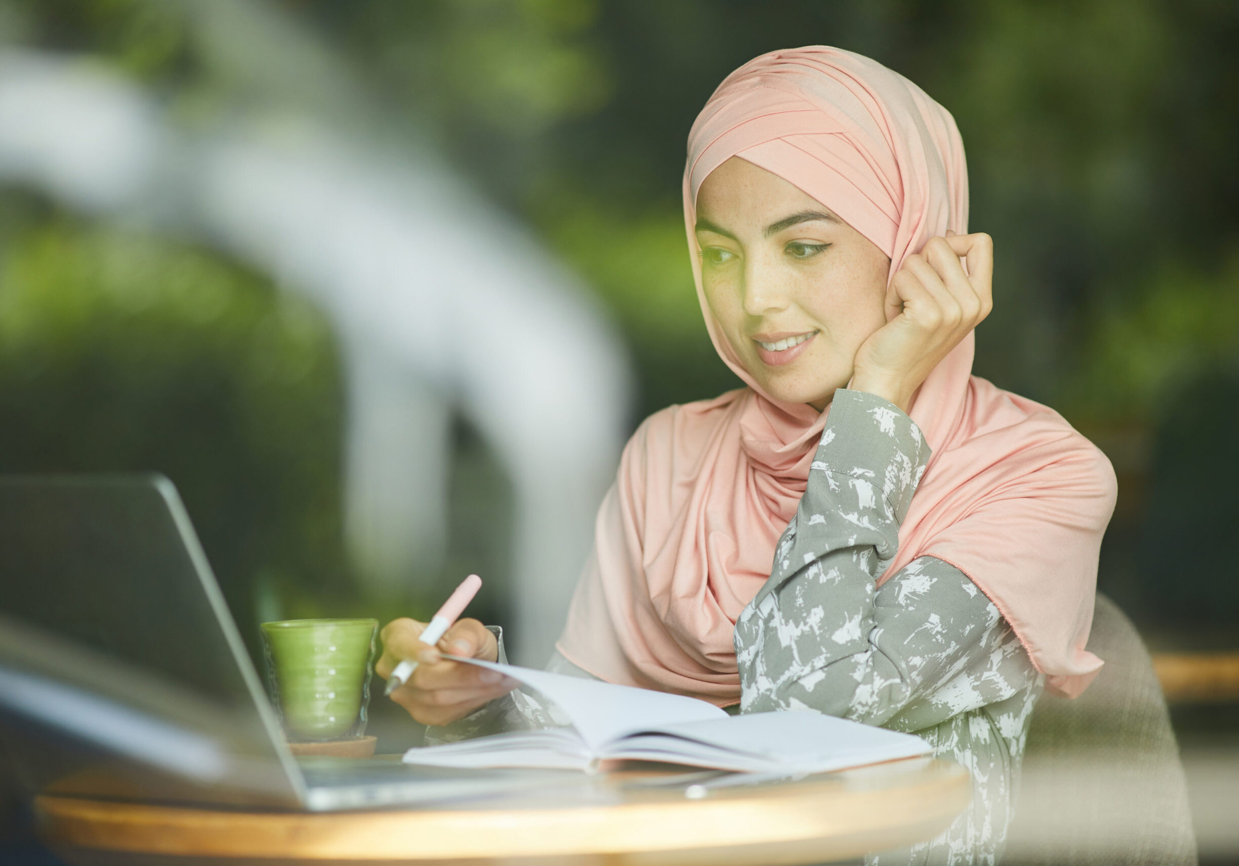 woman in hijab watching webinar